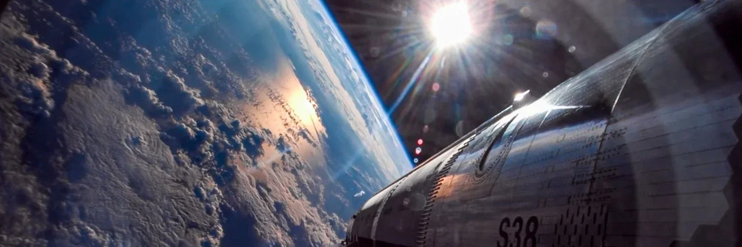 Earth and a metallic spacecraft in sunlight