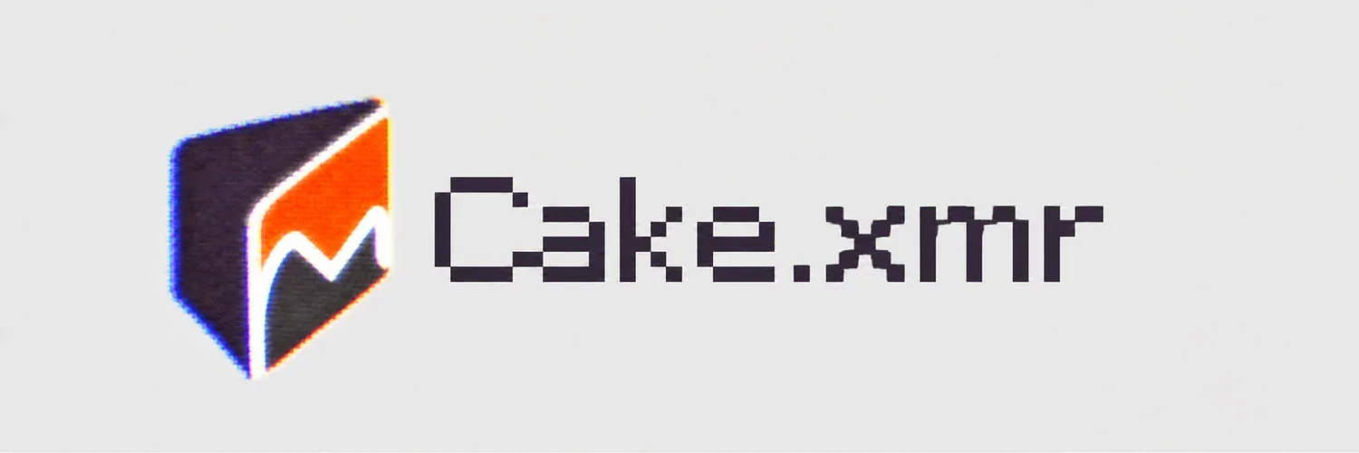 Black and orange wallet bearing a white M beside pixelated Cake.xmr lettering on a pale background.